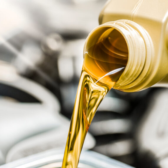 Viscous crude oil flowing from a container, illustrating petroleum production and energy resources.