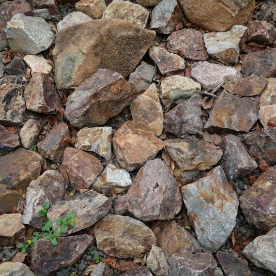 Close-up of various natural mineral rocks in earthy tones, representing raw mineral materials.